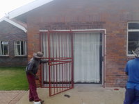 Swing door security gate with sold section